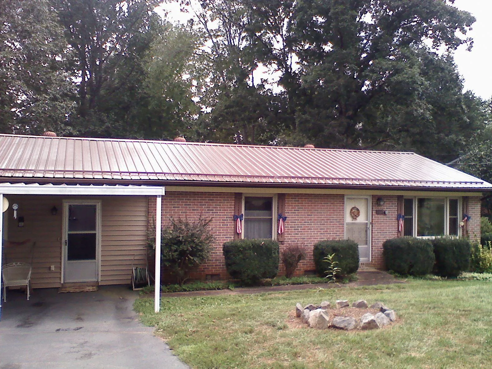 Bronze metal roof and carport on a brick ranch home — Roof Repair work by our crew in Delta